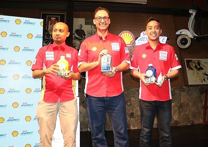 people posing with shell lubricant product can