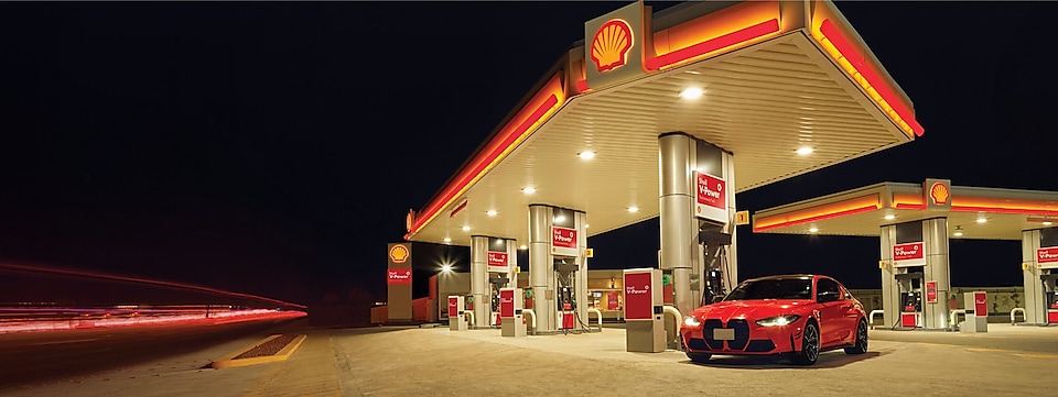 Red car in shell  fuel station