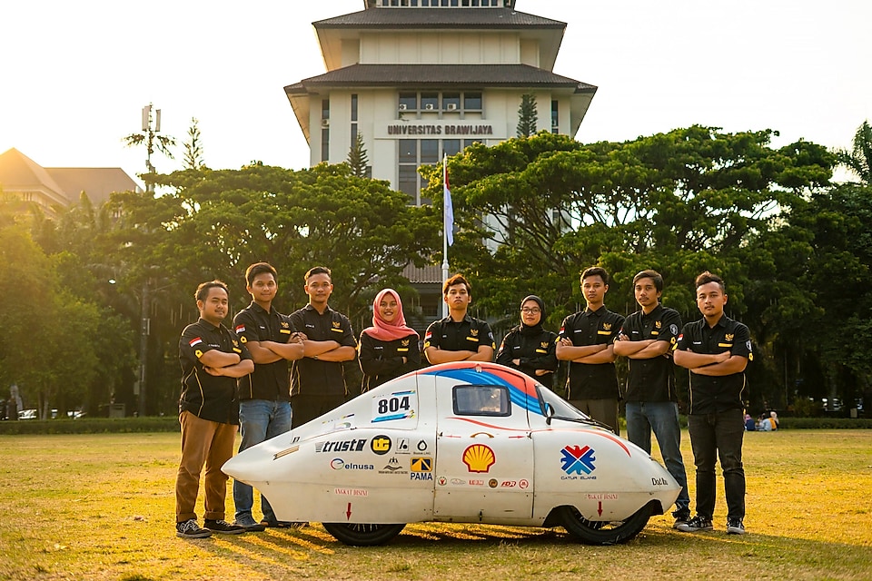 Apatte62 Team with an energy-efficient car as a result of their innovation. (Photo was taken before the pandemic)