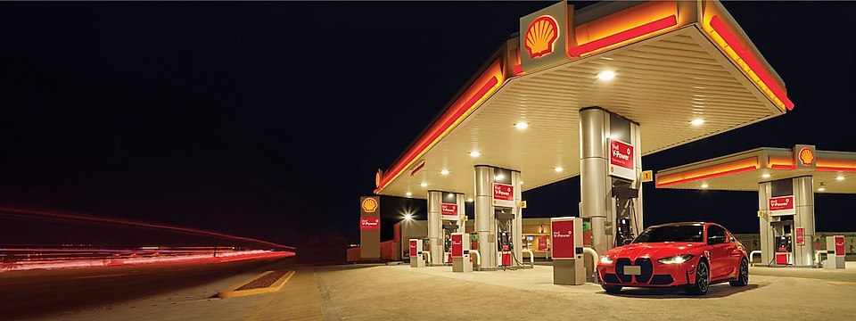 Red car in shell  fuel station