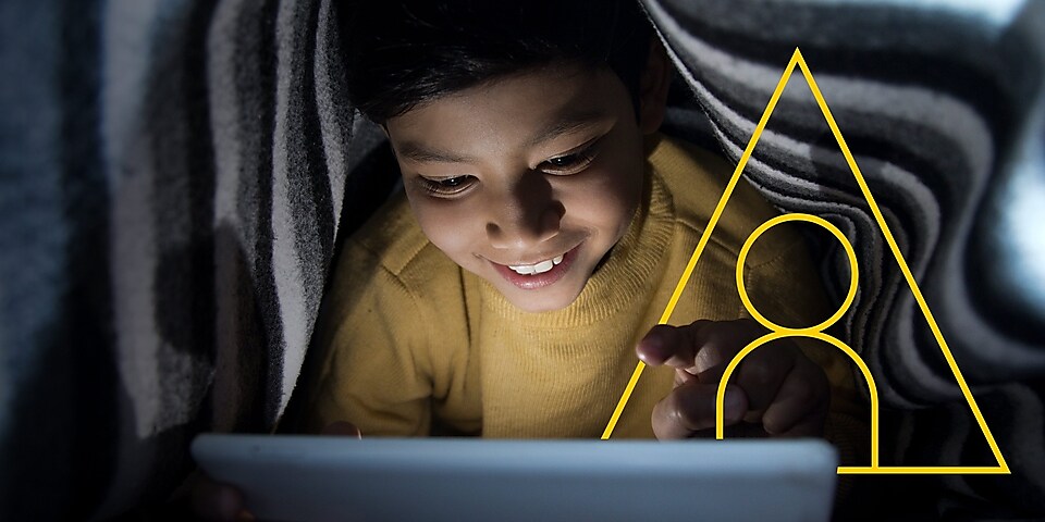 Foto seorang anak laki-laki sedang melihat layar tabletnya dengan tulisan menggerakkan kehidupan
