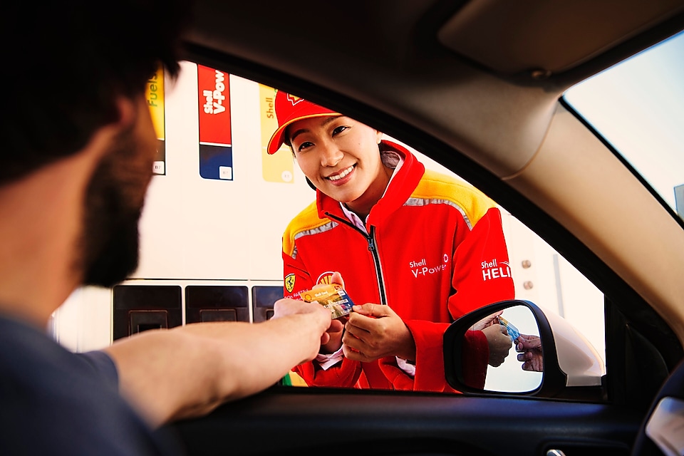 Man making payment by Shell card at petrol pump