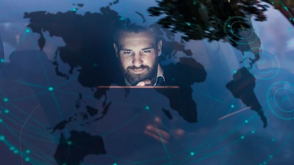 Businessman with tablet in car at night surrounded by data