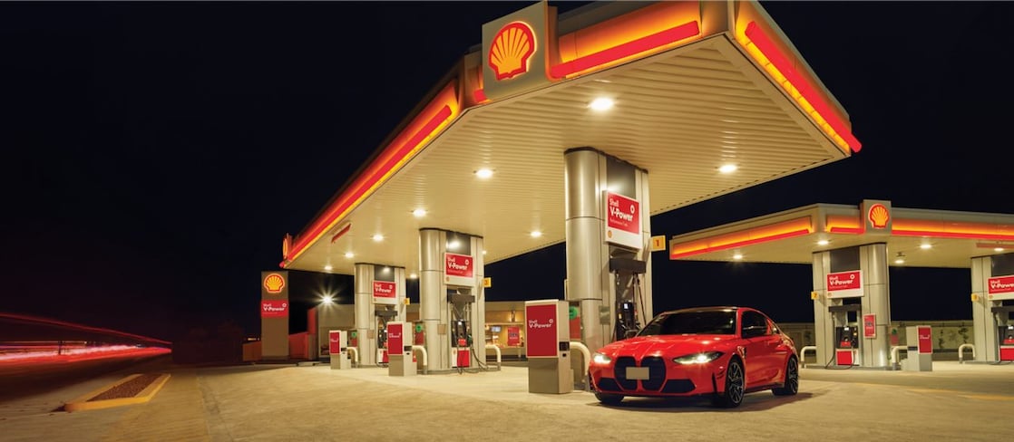 Red car in shell  fuel station