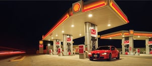 Red car in shell fuel station