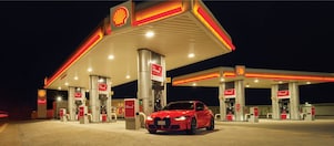 Red car in shell fuel station